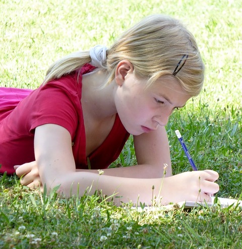 Girl Writes Poem in Grass pixabay 2017 cropped